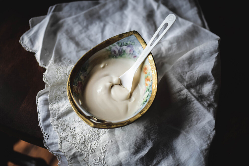 Decorative floral bowl filled with vegan sweet coconut cream.