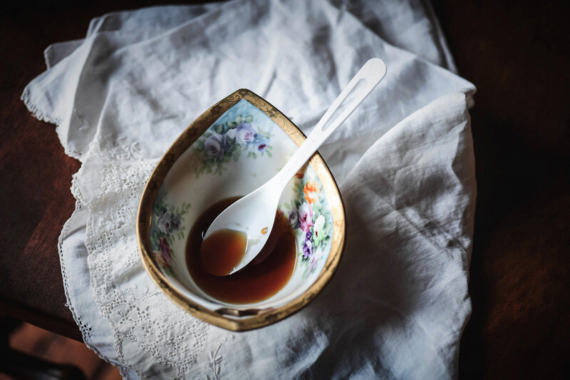 Floral decorative bowl filled with maple syrup.