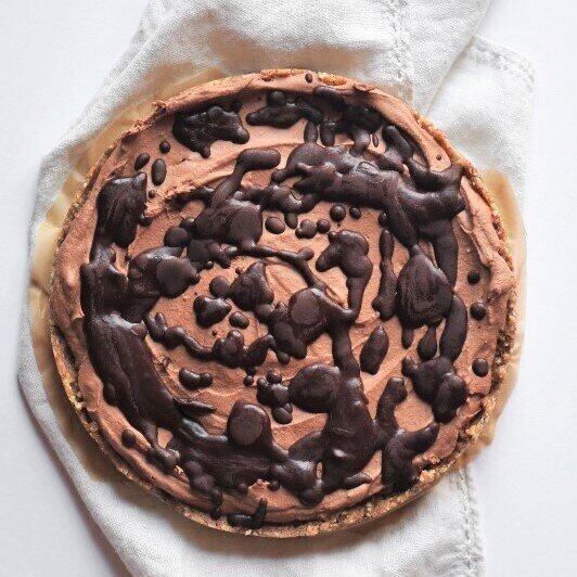 Gluten free and vegan no bake chocolate coconut pie drizzled with chocolate sauce.