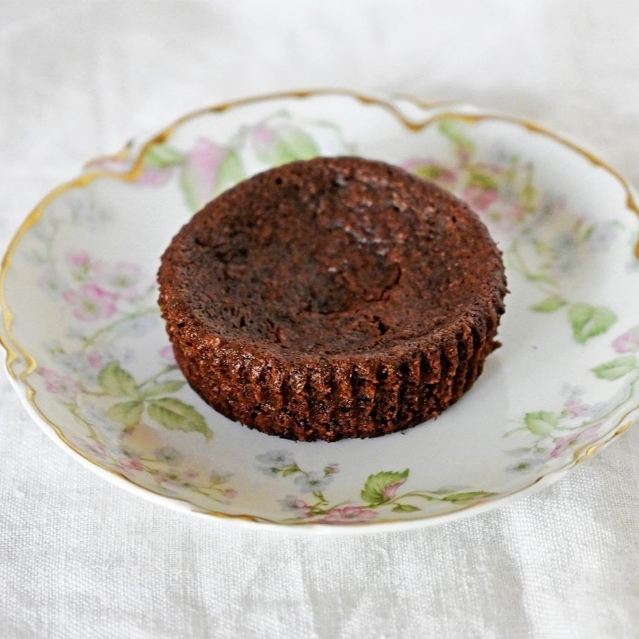 Gluten free and vegan brownie a la mode base atop decorative floral plate.