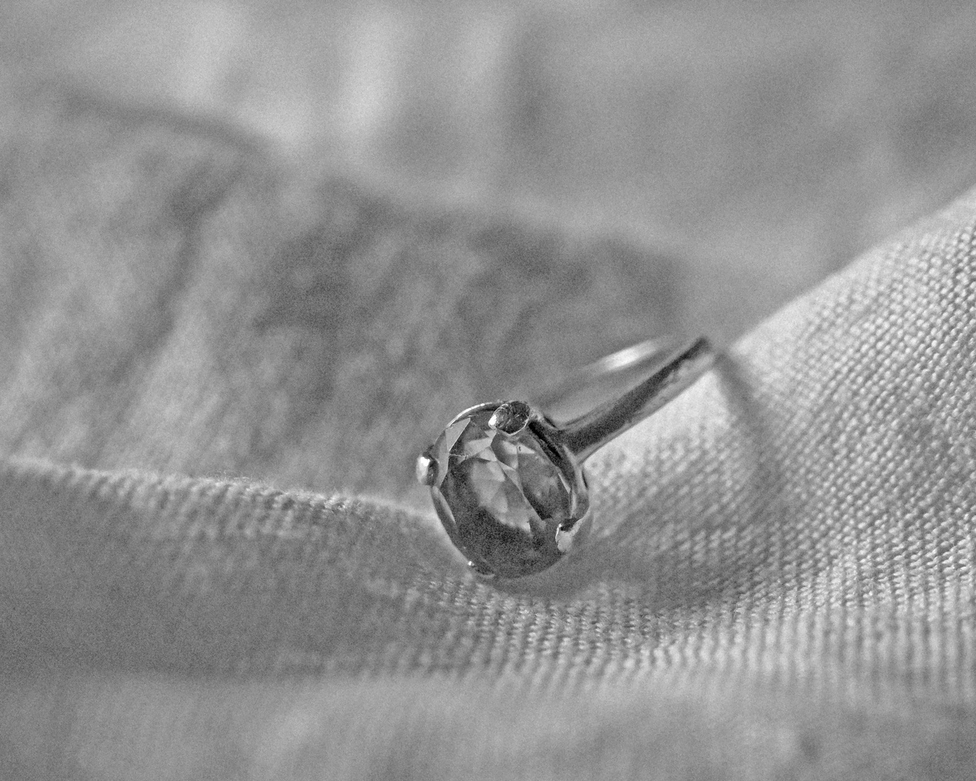 Black and white photo of vintage Black and white photo of vintage round cut topaz ring.